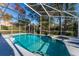 Sparkling screened-in pool with a spa, surrounded by a well-maintained deck and lush, mature landscaping at 607 Golden Dawn Ln, Apopka, FL 32712