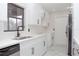 Well-lit kitchen featuring white cabinets, quartz countertops, stainless steel sink, and modern fixtures at 616 Ivanhoe Way, Casselberry, FL 32707