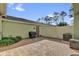 View of the brick paver patio featuring the exterior walls, door, and privacy fence at 6218 Forsythe Loop, Sanford, FL 32771