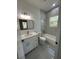 Stylish bathroom showcasing a tub with shower, vanity and great lighting at 6425 Curtis St, Orlando, FL 32807