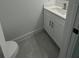 Bathroom featuring white vanity with marble countertop and grey tile flooring at 6425 Curtis St, Orlando, FL 32807