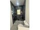 Sleek bathroom with black marble-like tile shower and designer fixtures at 6425 Curtis St, Orlando, FL 32807