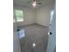 Bright bedroom with a ceiling fan, window views and tile flooring throughout at 6425 Curtis St, Orlando, FL 32807