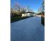 Rear view of the single-story home showcasing the spacious backyard and long driveway at 6425 Curtis St, Orlando, FL 32807