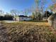 The single-story home has an attached garage, a gray exterior, and is surrounded by trees at 6425 Curtis St, Orlando, FL 32807