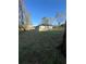 View of the single-story home in a serene setting with a large grassy area at 6425 Curtis St, Orlando, FL 32807