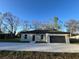 Charming single-story home with a well-maintained lawn, a gray exterior, and an attached garage at 6425 Curtis St, Orlando, FL 32807