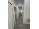 Hallway with white doors, gray tile floors, and neutral walls at 6425 Curtis St, Orlando, FL 32807