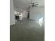 Living space with an open layout, ceiling fan, views of the kitchen, and tile flooring at 6425 Curtis St, Orlando, FL 32807