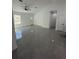 Bright living room with an open concept, tile floors, and a white door at 6425 Curtis St, Orlando, FL 32807