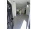 An open-concept living space showcases new gray tile floors, with views of the kitchen at 6425 Curtis St, Orlando, FL 32807