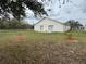 View of the home's backyard and a partial view of the house at 649 Gazelle Dr, Kissimmee, FL 34759