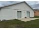 Shot of backyard, patio and siding of house with two sliding glass doors at 649 Gazelle Dr, Kissimmee, FL 34759