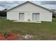 Backyard with dual sliding doors and a concrete patio at 649 Gazelle Dr, Kissimmee, FL 34759