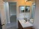 Bathroom with vanity sink and mirror; view to hallway at 649 Gazelle Dr, Kissimmee, FL 34759