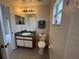 This bathroom has a granite vanity, tile flooring, and well-lit modern fixtures at 649 Gazelle Dr, Kissimmee, FL 34759