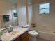 Bright bathroom featuring a bathtub and shower combination, vanity with sink, and tiled walls at 649 Gazelle Dr, Kissimmee, FL 34759