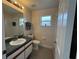 Well-lit bathroom features a window, a toilet, a shower, and a vanity at 649 Gazelle Dr, Kissimmee, FL 34759