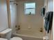 Bright bathroom featuring a bathtub and shower combination and tiled walls at 649 Gazelle Dr, Kissimmee, FL 34759