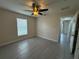 This is a spacious bedroom with a ceiling fan and tile flooring at 649 Gazelle Dr, Kissimmee, FL 34759