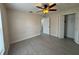 Bedroom featuring ceiling fan, tiled floor, and walk-in closet at 649 Gazelle Dr, Kissimmee, FL 34759