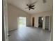 Large bedroom with tile flooring, vaulted ceilings, and a sliding glass door to the backyard at 649 Gazelle Dr, Kissimmee, FL 34759