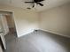 This bedroom features a ceiling fan, tiled floor and base molding at 649 Gazelle Dr, Kissimmee, FL 34759