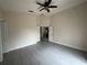 Spacious bedroom with updated tile flooring, ceiling fan, and access to the bathroom at 649 Gazelle Dr, Kissimmee, FL 34759