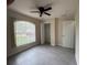 This bedroom features a ceiling fan, tiled floor and a closet for ample storage at 649 Gazelle Dr, Kissimmee, FL 34759