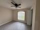 This bedroom features a ceiling fan, tiled floor and a closet for ample storage at 649 Gazelle Dr, Kissimmee, FL 34759