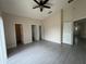 Spacious bedroom with updated tile flooring, ceiling fan, and access to the bathroom and living areas at 649 Gazelle Dr, Kissimmee, FL 34759