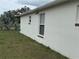 View of backyard, side of house, window and portion of fence at 649 Gazelle Dr, Kissimmee, FL 34759