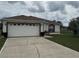 Charming single-story home with a large garage and driveway at 649 Gazelle Dr, Kissimmee, FL 34759