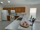 Bright kitchen featuring tile floors, white appliances, ample counter space, and a breakfast bar with seating at 649 Gazelle Dr, Kissimmee, FL 34759