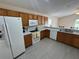 This bright kitchen features wood cabinets, white appliances, and a breakfast bar, perfect for casual dining at 649 Gazelle Dr, Kissimmee, FL 34759