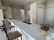 View of the kitchen bar, which features gray tile floors, bar stool seating, and ample lighting at 649 Gazelle Dr, Kissimmee, FL 34759