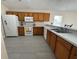 Bright kitchen featuring tile floors, white appliances, ample counter space, and a breakfast bar with seating at 649 Gazelle Dr, Kissimmee, FL 34759