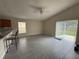 Open living room features vaulted ceiling, ceiling fan, and sliding glass doors to the backyard at 649 Gazelle Dr, Kissimmee, FL 34759