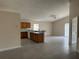 Open concept living area features tile floors, a vaulted ceiling, fan, and sliding glass doors to the backyard at 649 Gazelle Dr, Kissimmee, FL 34759