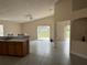 Open concept living area features tile floors, vaulted ceiling, fan, and sliding glass doors to the backyard at 649 Gazelle Dr, Kissimmee, FL 34759