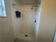 All-white tiled shower stall includes shower head, shower faucet, and shelf at 649 Gazelle Dr, Kissimmee, FL 34759