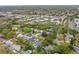 An aerial shot displays a neighborhood with a mix of housing styles and manicured landscaping, surrounded by lush trees at 701 Denton Rd, Winter Park, FL 32792