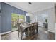 Elegant dining room featuring natural light, stylish chandelier, and tile flooring at 701 Denton Rd, Winter Park, FL 32792