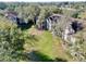 Scenic view of condo building with a large, well-maintained green lawn surrounded by trees at 7147 Yacht Basin Ave # 115, Orlando, FL 32835