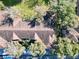 Aerial view of condo rooftops nestled among mature trees and green spaces at 7147 Yacht Basin Ave # 115, Orlando, FL 32835