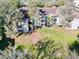 A stunning view of a condo building and its meticulously kept green lawn, surrounded by mature trees at 7147 Yacht Basin Ave # 115, Orlando, FL 32835