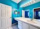 Vibrant bathroom featuring dual sinks, ample countertop space, and a well-lit mirror at 7147 Yacht Basin Ave # 115, Orlando, FL 32835