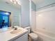 Standard bathroom features a tub with a shower, single sink vanity with a framed mirror, and a toilet at 7147 Yacht Basin Ave # 115, Orlando, FL 32835