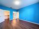 Bright bedroom featuring wood-look floors and easy access to the walk-in closet and bathroom at 7147 Yacht Basin Ave # 115, Orlando, FL 32835