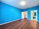 Bedroom featuring wood-look floors and easy access to the walk-in closet and bathroom at 7147 Yacht Basin Ave # 115, Orlando, FL 32835